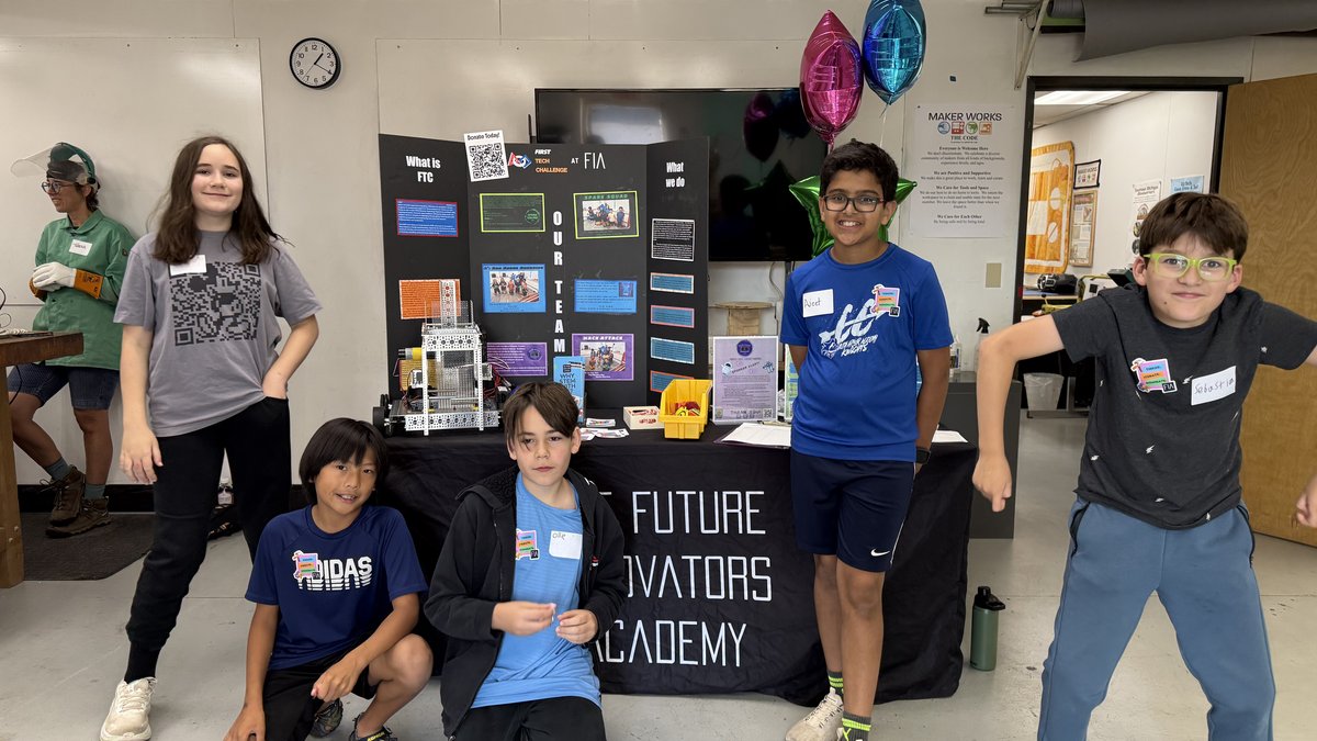 Five FIA students in front of the Future Innovators Academy outreach booth at Maker Works.